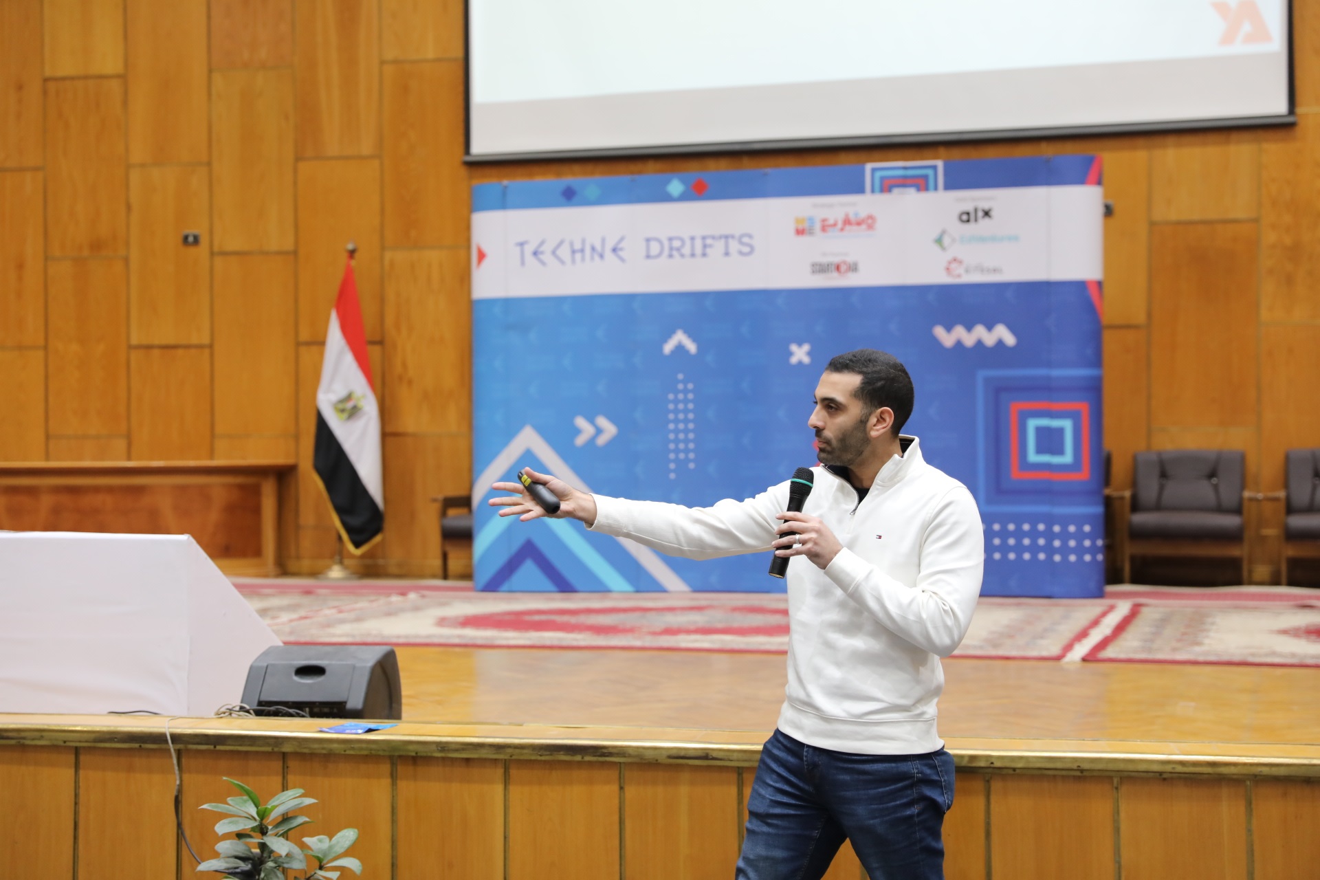 Youssef El Akkari speaking on stage